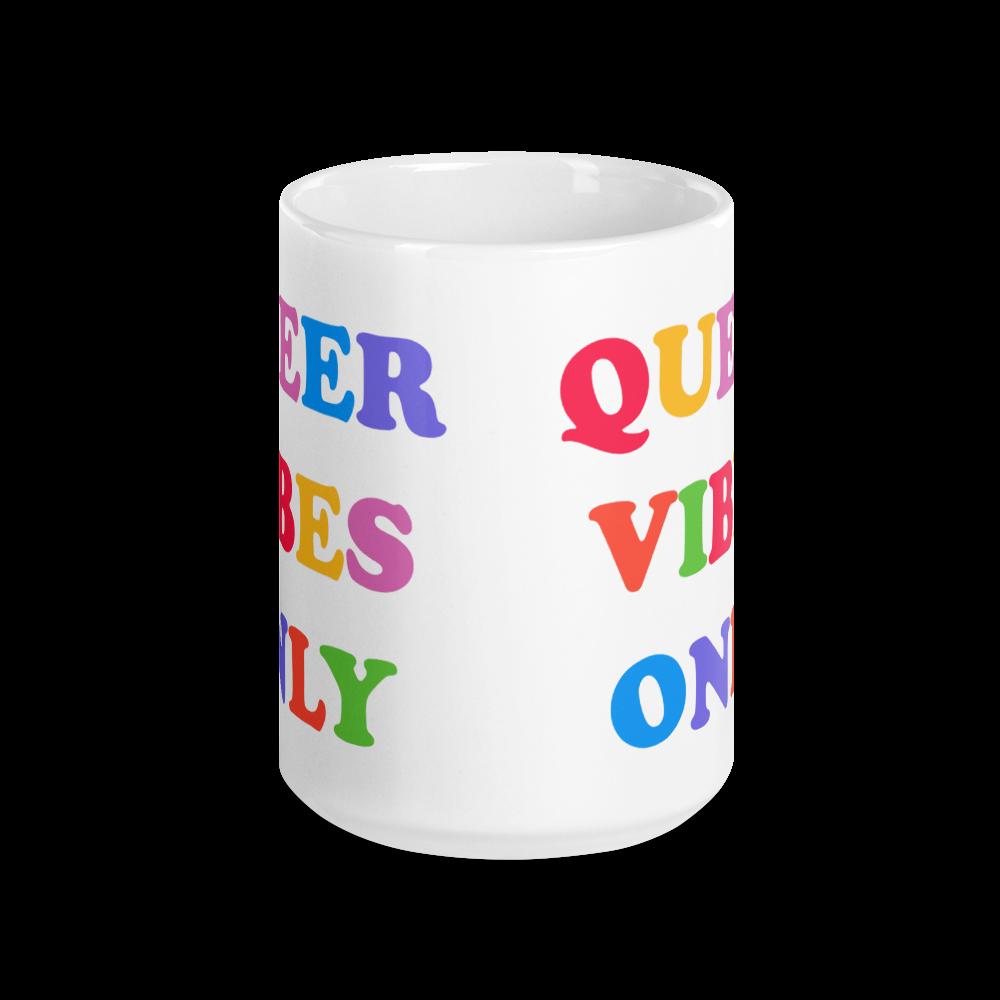 15 0z Pride mug that says Queer Vibes in rainbow retro writing- shop feminist trash for pride clothing, political t shirts, feminist apparel and dump him shirts