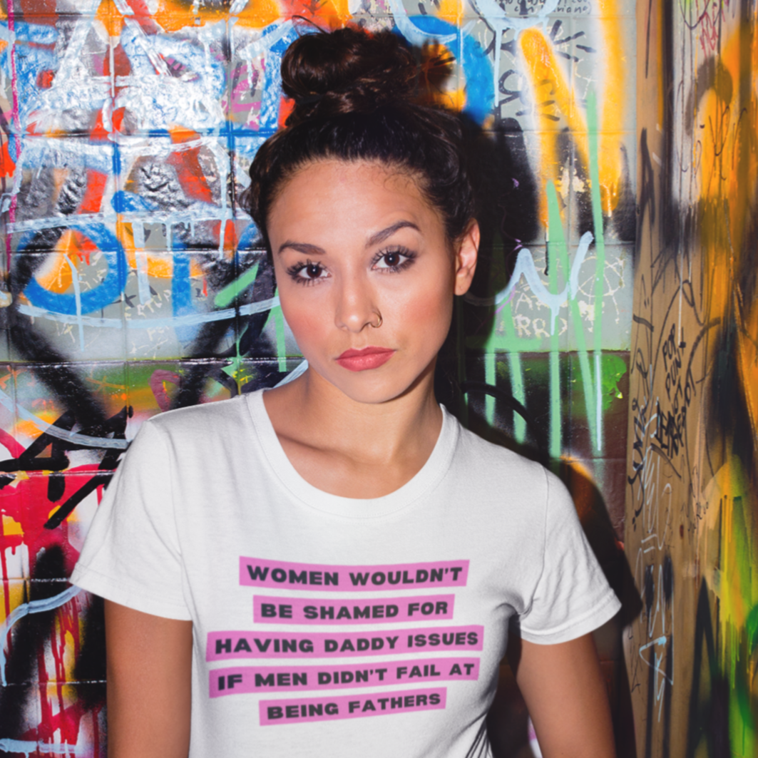 White feminist tee that says women wouldn't be shamed for having daddy issues if men didn't fail at being fathers in black news style writing with a pink background- Shop feminist trash for feminist tees and dump him shirts