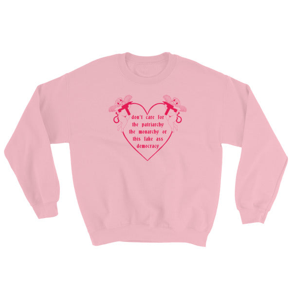 pink  feminist sweatshirt that says Don’t Care For The Patriarchy, The Monarchy Or This Fake Ass Democracy in red writing surrounded by angel cherubs holding guns- shop feminist sweatshirts and dump him shirts
