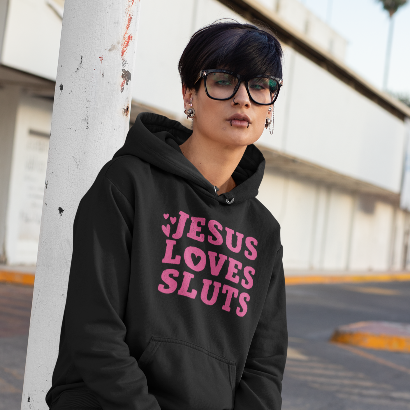 Black Feminist Hoodie that says Jesus Loves Sluts In red writing featuring three love hearts. Shop Feminist Trash for feminist sweatshirts, political clothing, dump him shirts, witchy outfits and pride tshirts