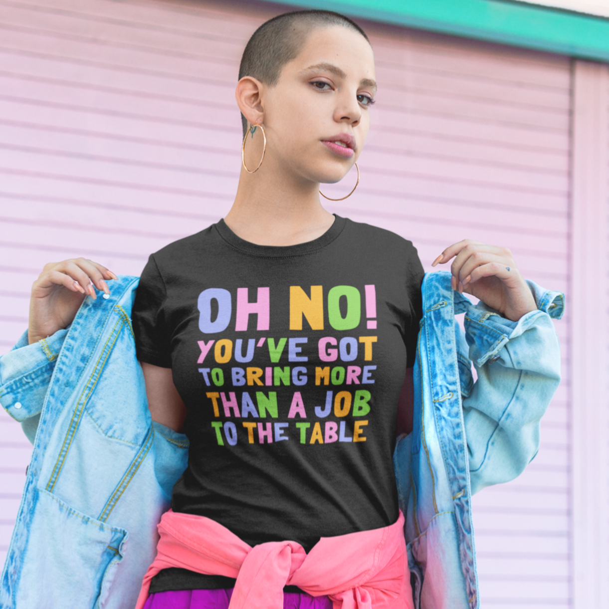 black feminist tshirt that says Oh No! You’ve Got To Bring More Than A Job To The Table in blue, pink, yellow and green writing.- Shop Women’s Rights T-shirts and feminist tees