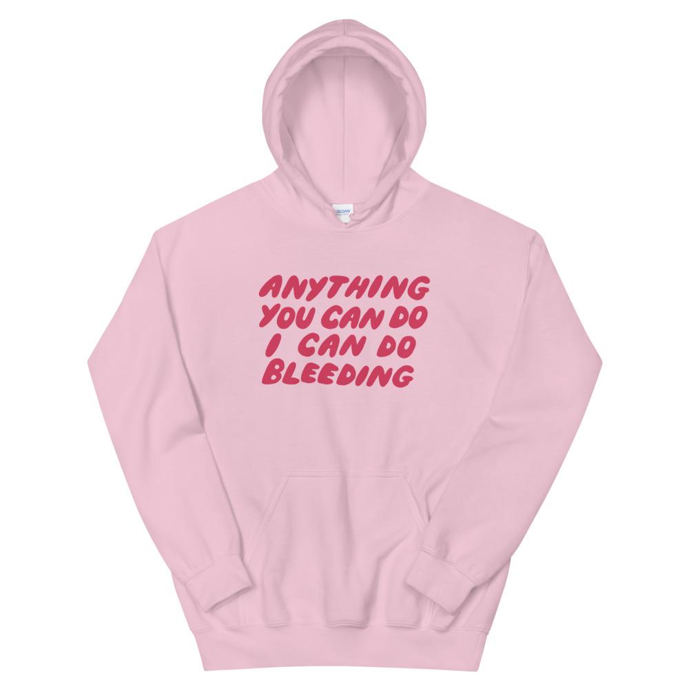Pink feminist hoodie that says Anything You Can Do I Can Do Bleeding in red bubble writing - Shop Women’s Rights apparel and dump him shirts