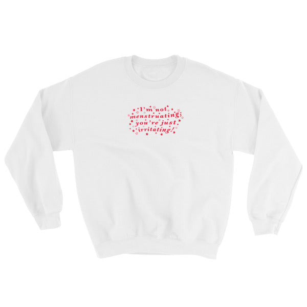 white feminist sweatshirt that says I’m Not Menstruating You’re Just Irritating in red wavy writing with stars surrounding it- define feminism with our feminist apparel
