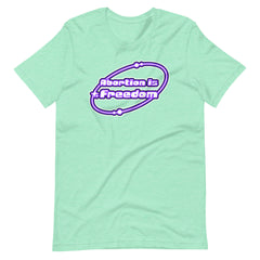 heathered mint green coloured feminist tshirt that says abortion is freedom in a purple and white y2k circular graphic. Shop Feminist Trash for pro choice tshirts and political clothes