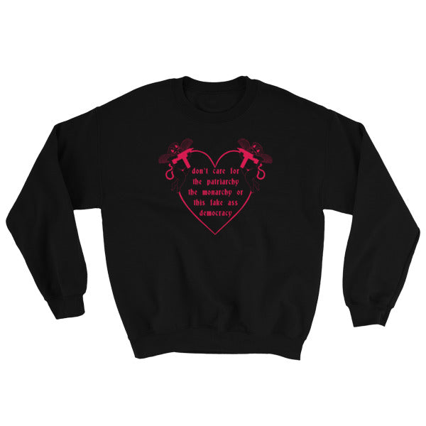black feminist sweatshirt that says Don’t Care For The Patriarchy, The Monarchy Or This Fake Ass Democracy in red writing surrounded by angel cherubs holding guns- shop feminist sweatshirts and dump him shirts