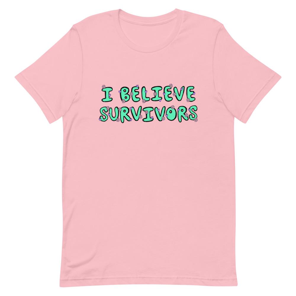 pink feminist t-shirt that says believe survivors in green bubble writing with tiny purple daisy illustrations. Shop Feminist Trash for political clothing, pride outfits, feminist apparel, dump him shirts and witchy outfits