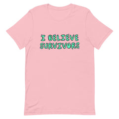 pink feminist t-shirt that says  believe survivors in green bubble writing with tiny purple daisy illustrations. Shop Feminist Trash for political clothing, pride outfits, feminist apparel, dump him shirts and witchy outfits