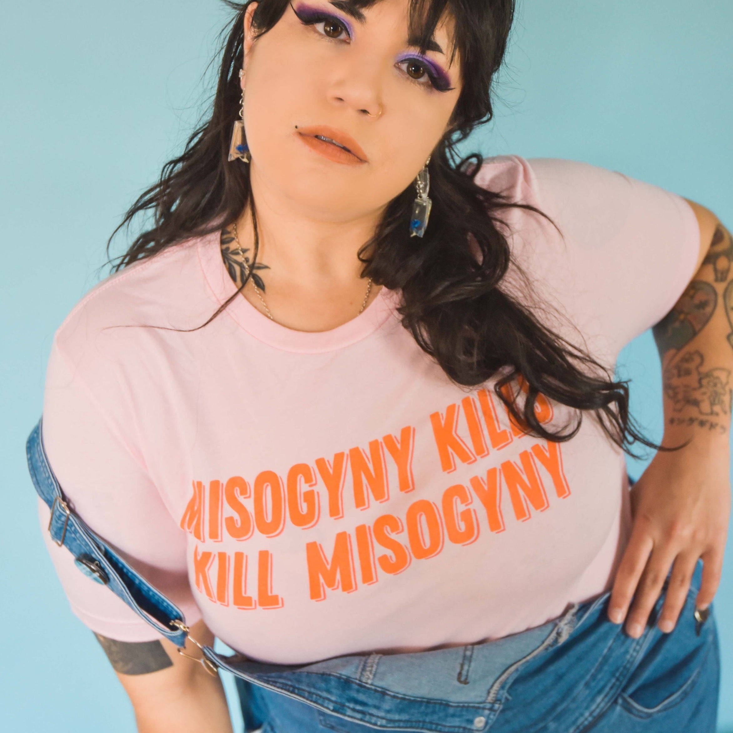 Pink feminist tshirt that says Misogyny Kills Kill Misogyny in orange writing- Shop Feminist Trash for feminist tshirts, political shirts, dump him sweatshirt, witchy outfits and clothing for gay women