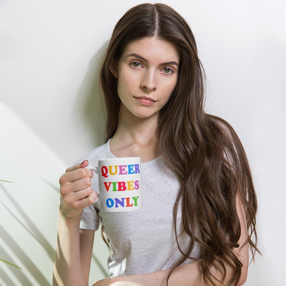 Pride mug that says Queer Vibes in rainbow retro writing- shop feminist trash for pride clothing, political t shirts, feminist tees and dump him shirts