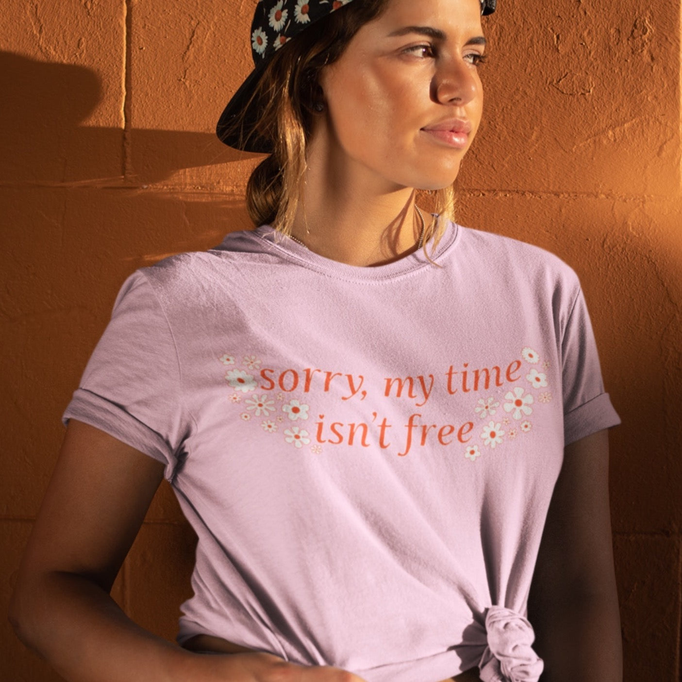 pink feminist tshirt that says sorry my time isn't free in orange writing surrounded by white flowers- shop feminist shirts, dump him shirts and political clothing