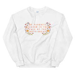 White feminist sweatshirt that says My Favorite Season Is The Fall Of The Patriarchy in bold orange writing surrounded by fall illustrations- shop Feminist Trash Store for Women’s Rights T-shirts, dump him shirts and political clothing