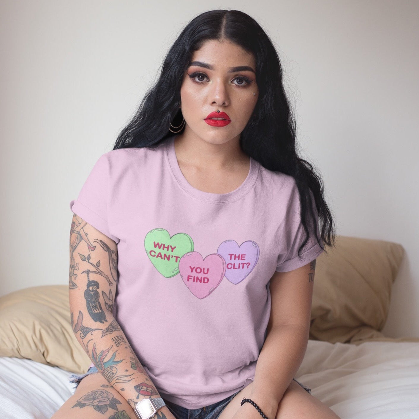 Pink feminist tshirt that says Why Can’t You Find The Clit? in three candy hearts- shop feminist apparel and dump him shirts
