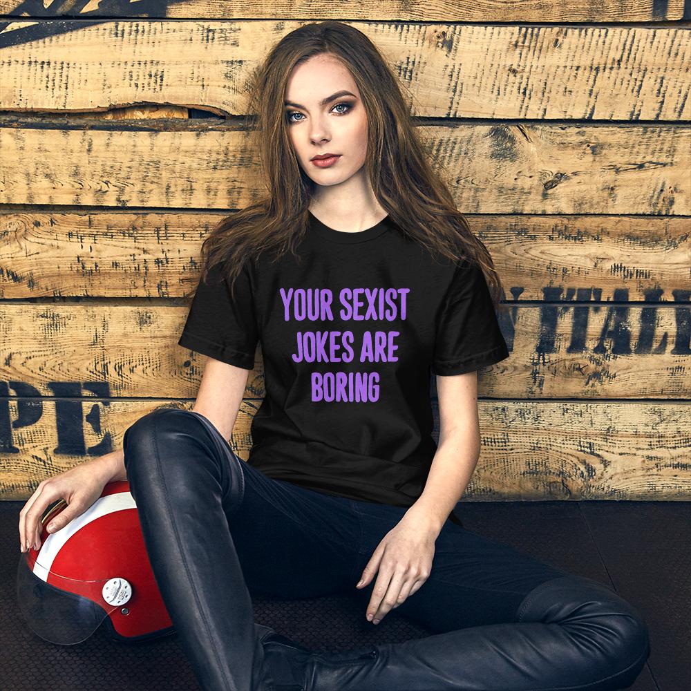 black feminist t- shirt that says Your Sexist Jokes Are Boring in bold purple writing. Define feminism with our feminist apparel, political clothing, pride clothing, and dump him shirts