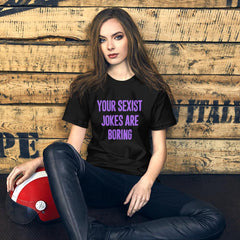 black feminist t- shirt that says Your Sexist Jokes Are Boring in bold purple writing. Define feminism with our feminist apparel, political clothing, pride clothing, and dump him shirts