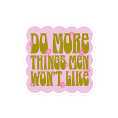 Empowering Feminist sticker featuring the phrase 'Do More Things Men Won’t Like' in a 70s retro lime army green font, with pink flower accents on a bubble pink background