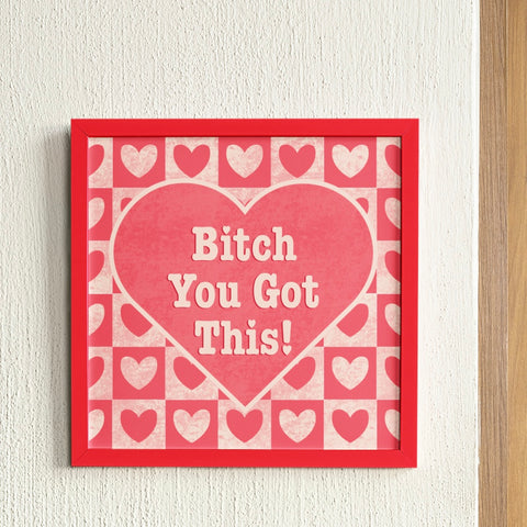 Feminist art print with cream text "Bitch, You Got This" on a red heart background, accented with a cream and red chequer heart pattern. Add a touch of retro flair to your space with this feminist art print. Shop feminist art prints for the empowered woman in all of us.