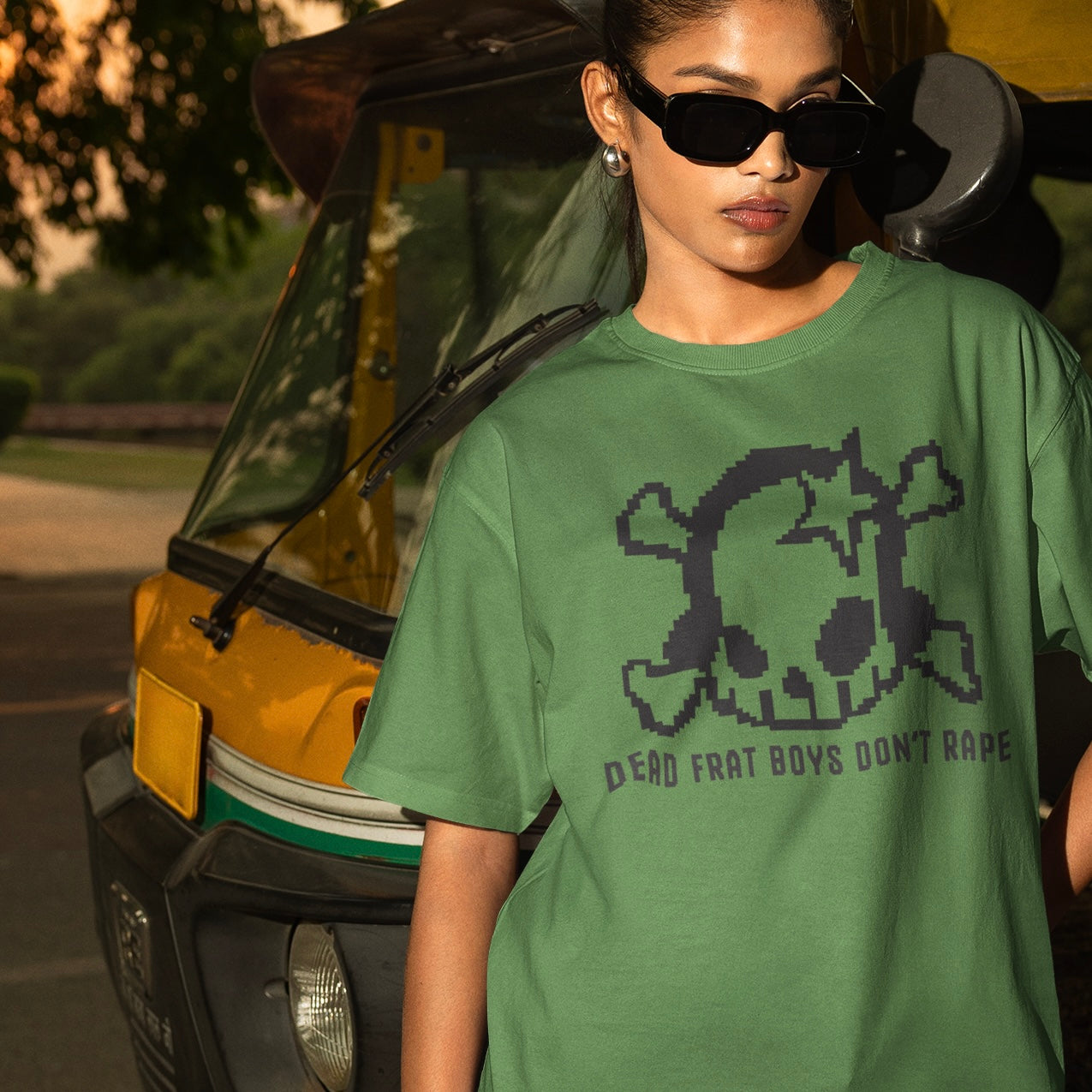 Leaf green feminist tee that says dead men don’t rape. Featuring a lofi pixel y2k skull 