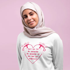 Hijabi wearing a white feminist hoodie that says Don’t Care For The Patriarchy, The Monarchy Or This Fake Ass Democracy -  Unisex Feminist Sweatshirt - Feminist Trash Store - Don’t Care For The Patriarchy, The Monarchy Or This Fake Ass Democracy Unisex Sweatshirt - Feminist Trash Store - Shop Women’s Rights T-shirts