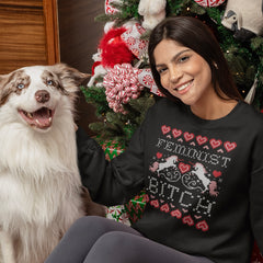 Feminist themed Ugly Christmas sweatshirt that says feminist bitch in cross stitch font featuring cross stitch unicorns and hearts. Shop feminist trash for feminist clothing and gifts for feminists.