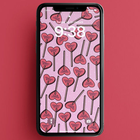 digital download of feminist phone wallpaper featuring a red heart lollipop pattern that says feminist bitch on a pink background. Shop feminist trash for cute phone wallpapers and feminist tshirts
