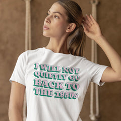 White feminist tshirt that says i will not quietly go back to the 1950s in pink and green bold retro writing- shop feminist apparel