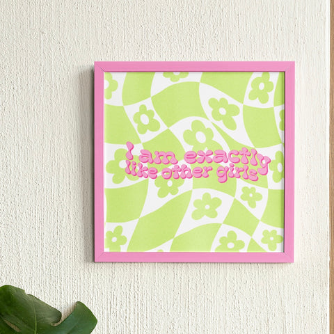 Feminist art print with the phrase "I Am Exactly Like Other Girls" in pink wavy retro writing, set against a green and white flower power checker print background. Shop feminist posters for the empowered woman in you.