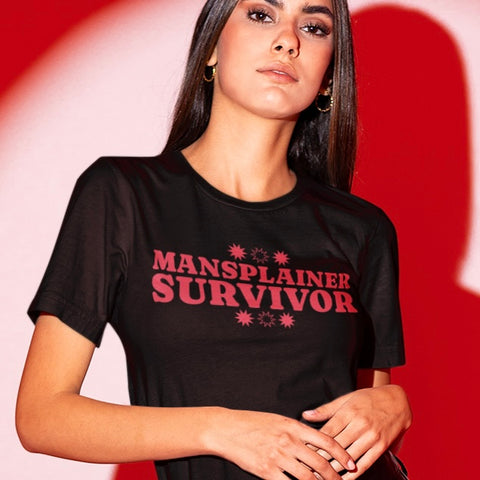 Image of a black feminist t-shirt with 'Mansplainer Survivor' in bold red lettering. This empowering feminist shirt is perfect for those who are sick of men explaining the obvious to them.