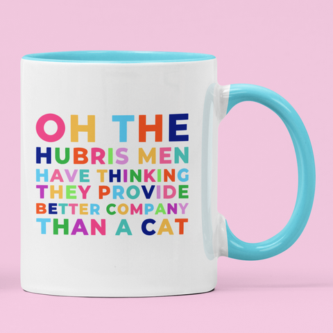 Feminist mug that says "oh the hubris men have thinking they provide better company than a cat" in rainbow writing. speak out against the men who think cat lady is an insult. Shop Feminist Mugs For The Empowered Woman