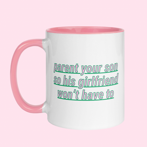 White feminist mug with the phrase "Parent your son so his girlfriend won't have to" in pink writing, accented with green details- Shop ceramic mugs for the empowered woman