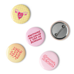 Set of five vibrant period positive feminist pins, featuring empowering slogans and designs challenging menstrual taboos. -Stop the catcalls with these feminist buttons