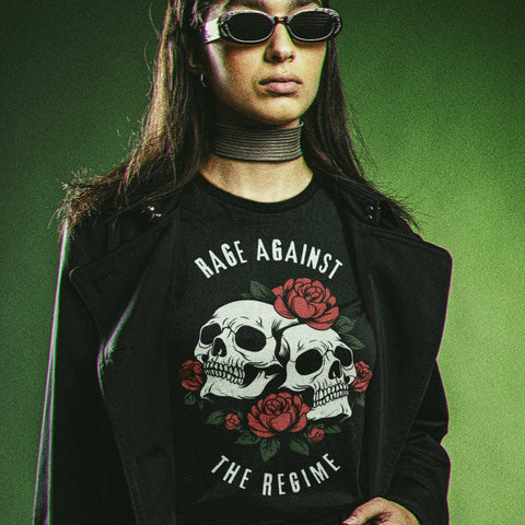 black political shirt that says rage against the regime in white writing- featuring two skulls surrounded by roses. Shop feminist trash for political shirts and anti fascist clothing.