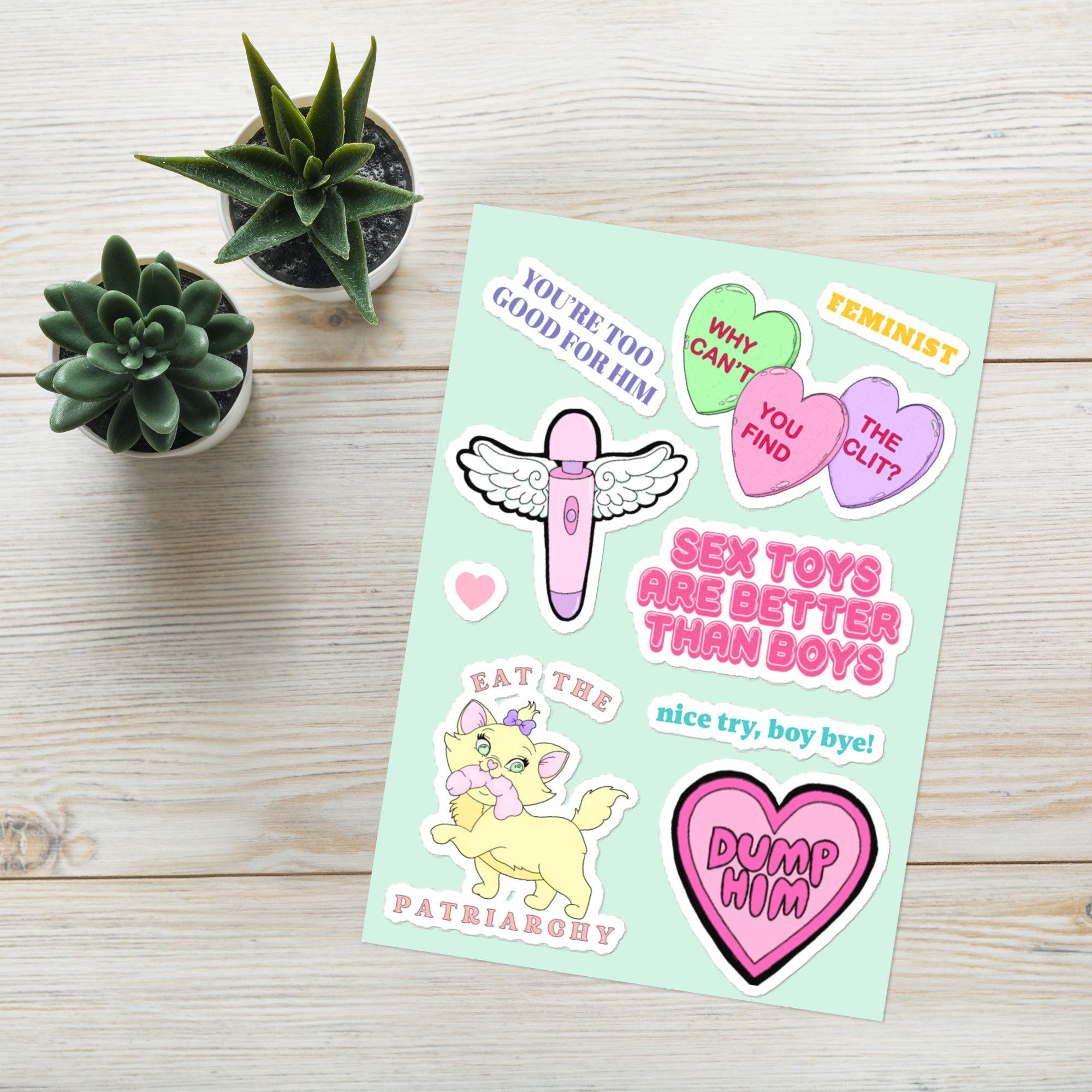 Feminist sticker sheet featuring empowering designs like 'Dump Him,' 'Sex Toys Are Better Than Boys,' 'You're Too Good for Him,' a cat eating the patriarchy, an angelic vibrator, and feminist candy heart- Shop feminist stickers