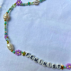 Teal seed bead feminist necklace with purple flowers and fresh water pearls.- shop feminist jewellery for the empowered woman