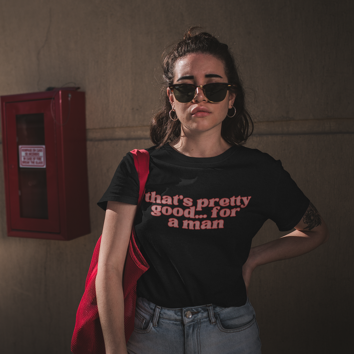 Black feminist shirt that says That’s Pretty Good For A Man in peach lowercase font outlined in red- Shop Feminist Trash for Women’s Rights T-shirts and Women's March Merchandise.