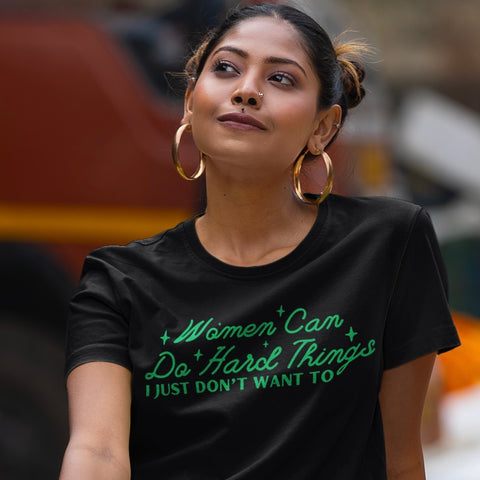 feminist tshirt featuring the phrase 'Women can do hard things, I just don't want to' in bold text. This feminist shirt is perfect for those looking for feminist tees that blend humor and empowerment. Shop our range of feminist shirts now!