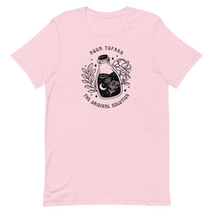 pink feminist t-shirt that says aqua tofana the original solution in black art nouveau sstyle writing. Featuring a black tattoo style illustration of a poison bottle- Shop feminist trash for feminist tees and dump im shirts.