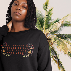 Black feminist sweatshirt with the empowering message 'My Favorite Season is the Fall of the Patriarchy,' advocating for empowerment and gender equality