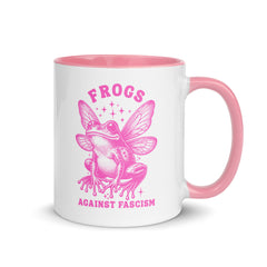 a pink fairy frog illustration with stars on a white coffee mug against a white background