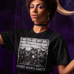 black political t-shirt that says felines against fascism in white writing- featuring a group of cats against a white brick wall. shop feminist trash for political clothing and witchy outfits