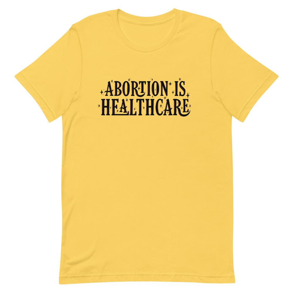 Yellow feminist shirt showcasing the importance of 'Abortion is Healthcare