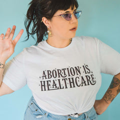 White feminist t shirt with 'Abortion is Healthcare' slogan