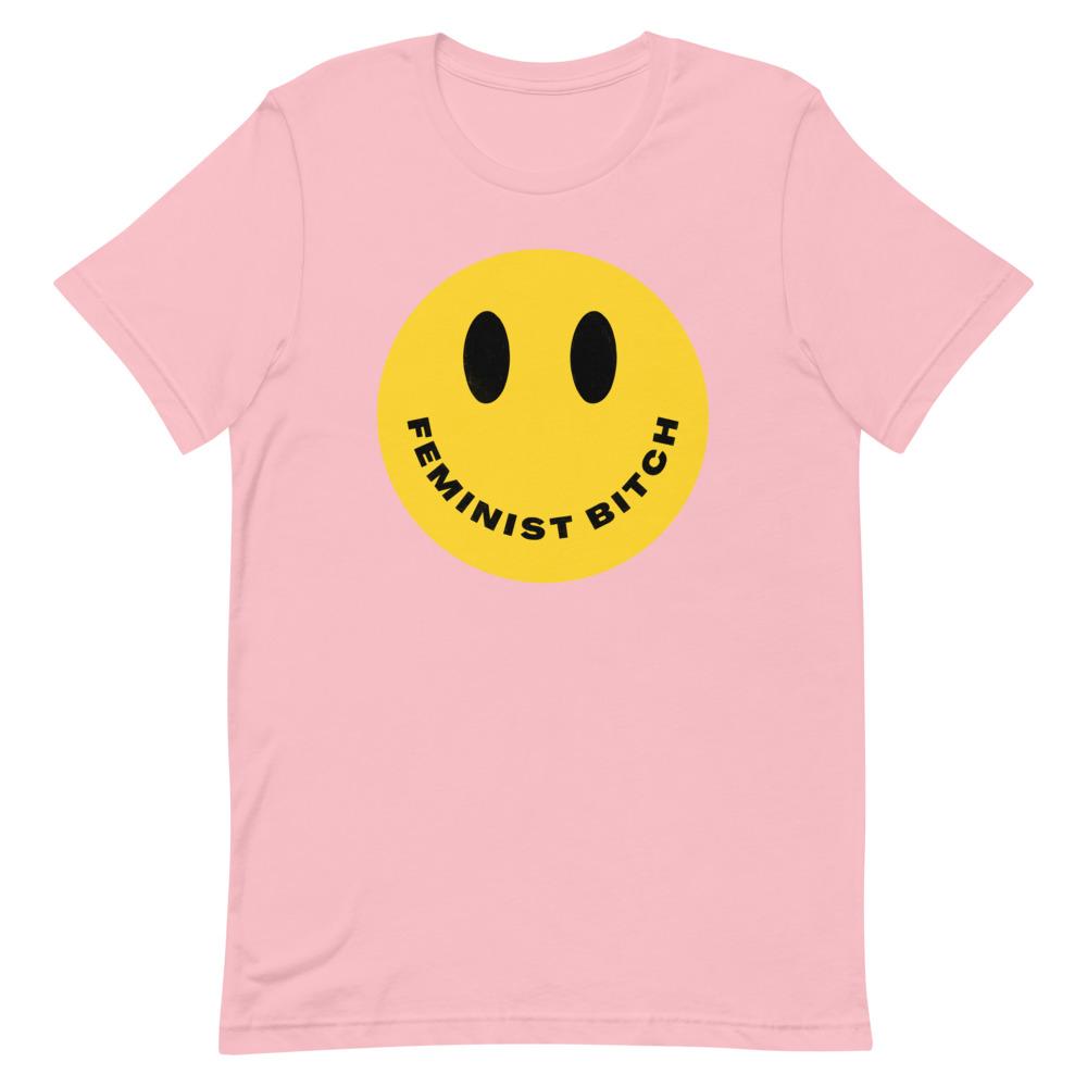 Pink feminist t shirt boldly stating "Feminist Bitch" with a yellow smiley face