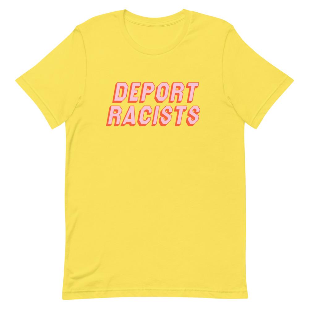 Yellow feminist t shirt conveying: "Deport Racists" in peach writing