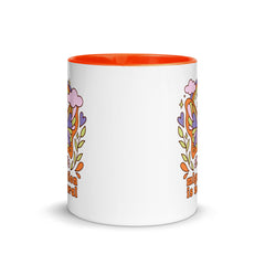 Side view of the Migration is Natural mug showing the bright orange interior and ergonomic handle design.