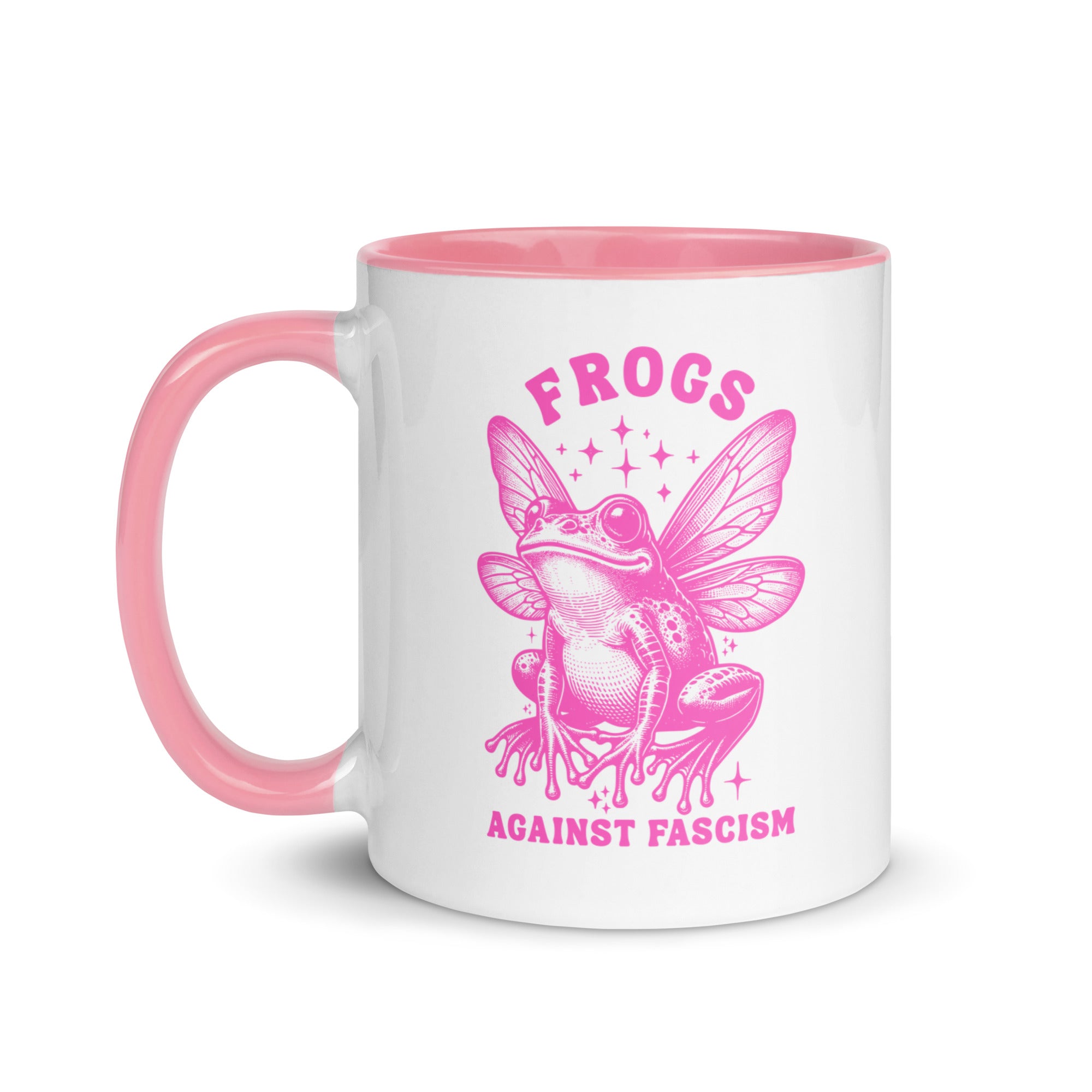 A white ceramic mug with a pink handle and rim featuring a pink fairy frog and the text "Frogs Against Fascism."