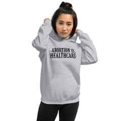 grey feminist hoodie that says abortion is healthcare in black hand lettered writing- shop pro choice clothing