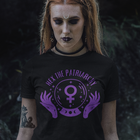 black feminist t-shirt that says hex the patriarchy in purple writing- featuring a crystal ball with the female symbol inside. shop feminist trash for witchy outfits and feminist t shirts