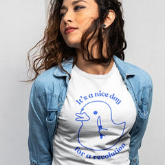 white political t-shirt that says its a nice day for a revolution in bold blue writing featuring a cute rubber duck holding a knife outline illustration- shop feminist trash for feminist tshirts, political clothing and outfits for pride.