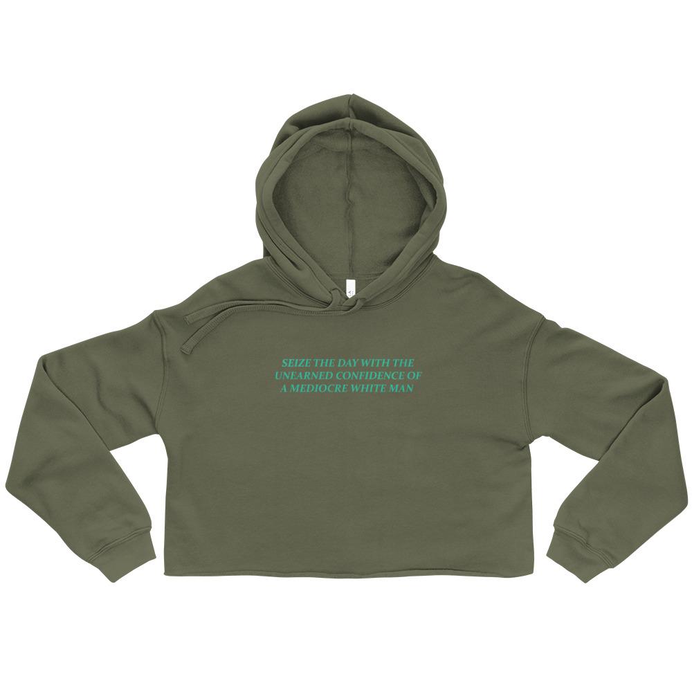 Military green feminist cropped hoodie featuring 'Seize the Day with the Unearned Confidence of a Mediocre White Man' text, promoting empowerment and equality. Shop feminist apparel