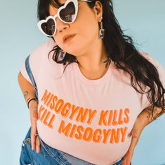 Pink feminist tee that says Misogyny Kills Kill Misogyny in orange bold hand lettered writing. Unisex Feminist T-Shirt - Feminist Trash Store - Shop Women’s Rights T-shirts
